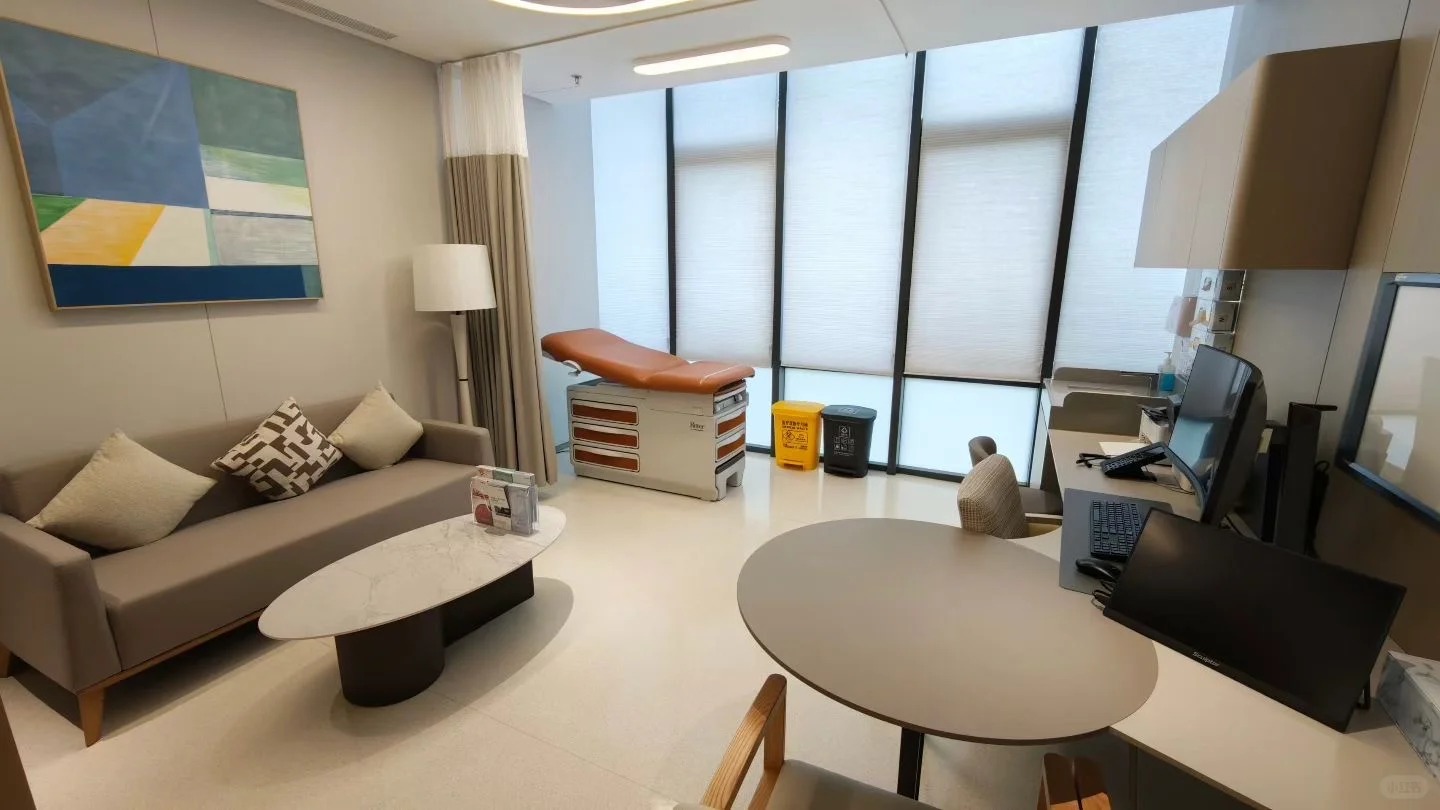 Comfortable consultation room with exam table sofa seating and large windows