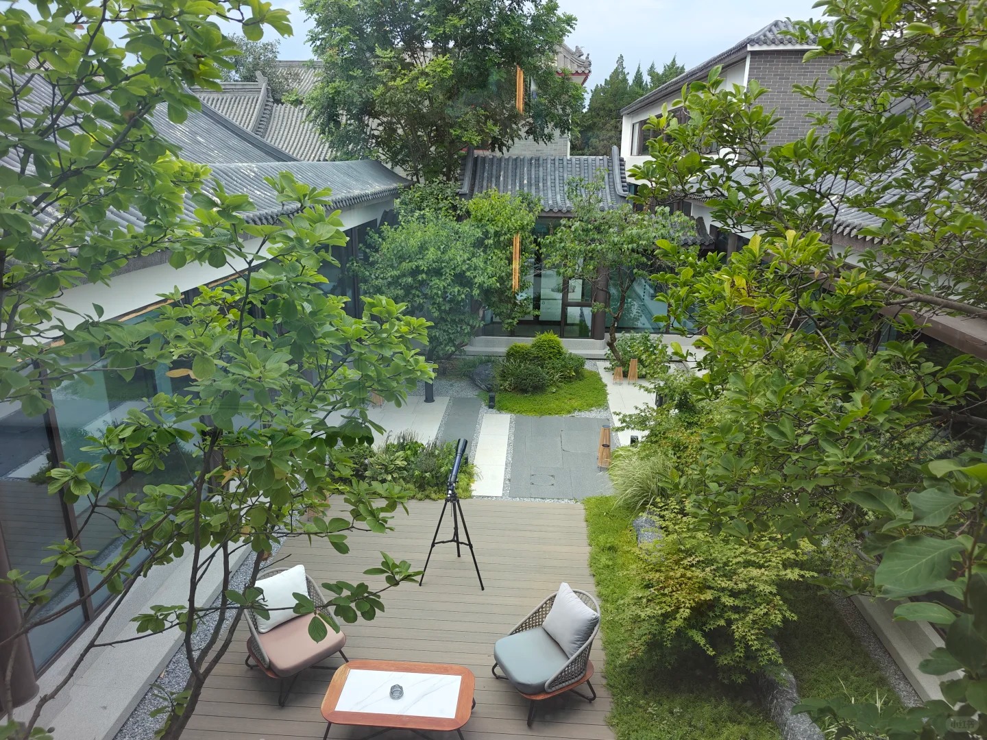Outdoor wooden deck seating area overlooking the healing garden