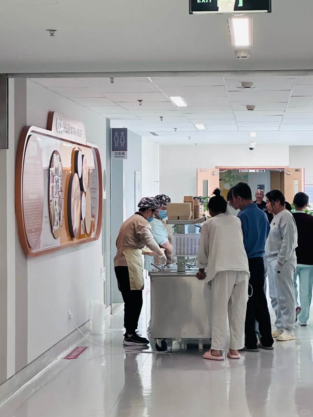 Nutritional meal service station with staff serving fresh meals to patients