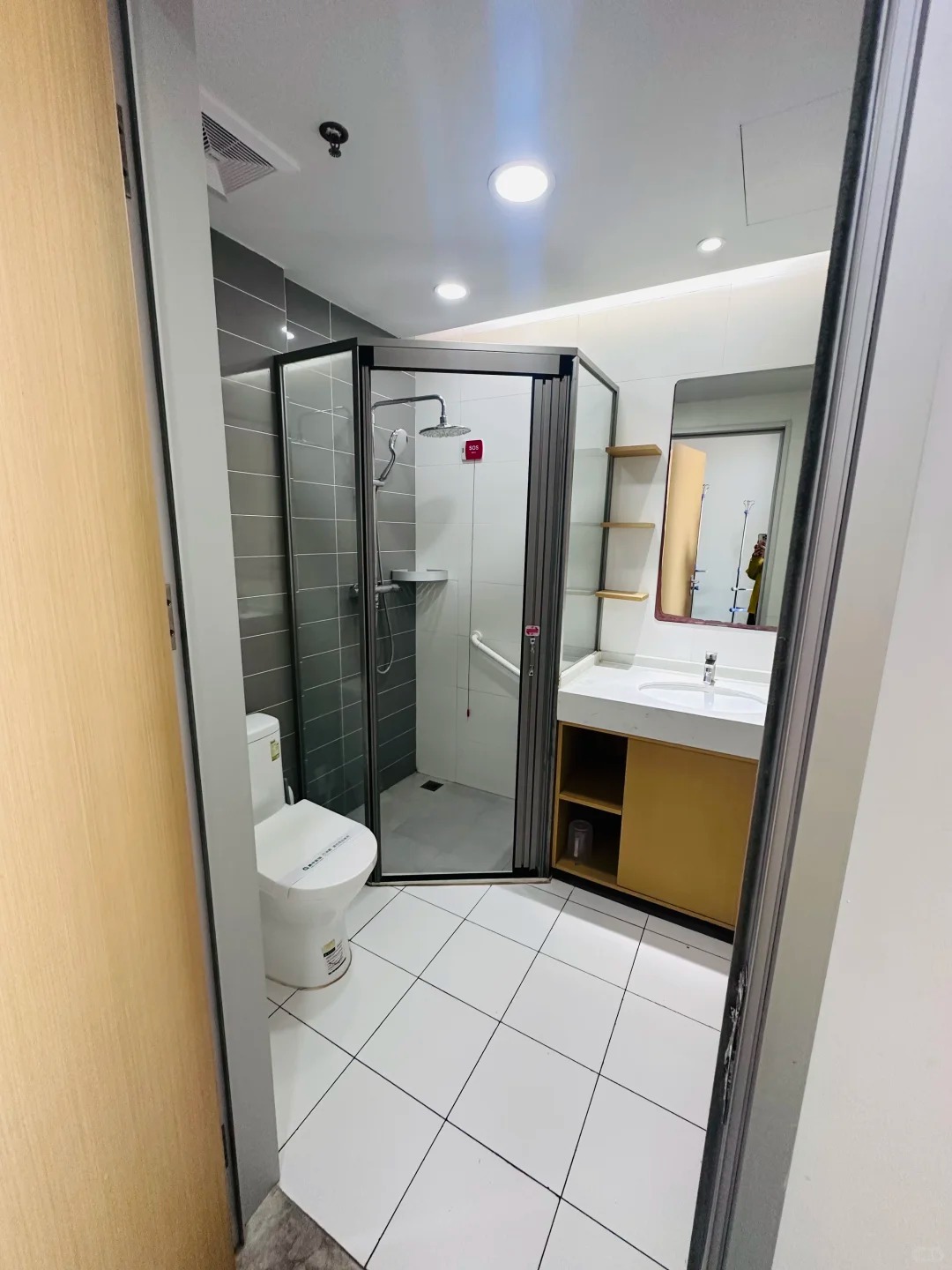 Modern patient bathroom with accessible shower and safety handrails