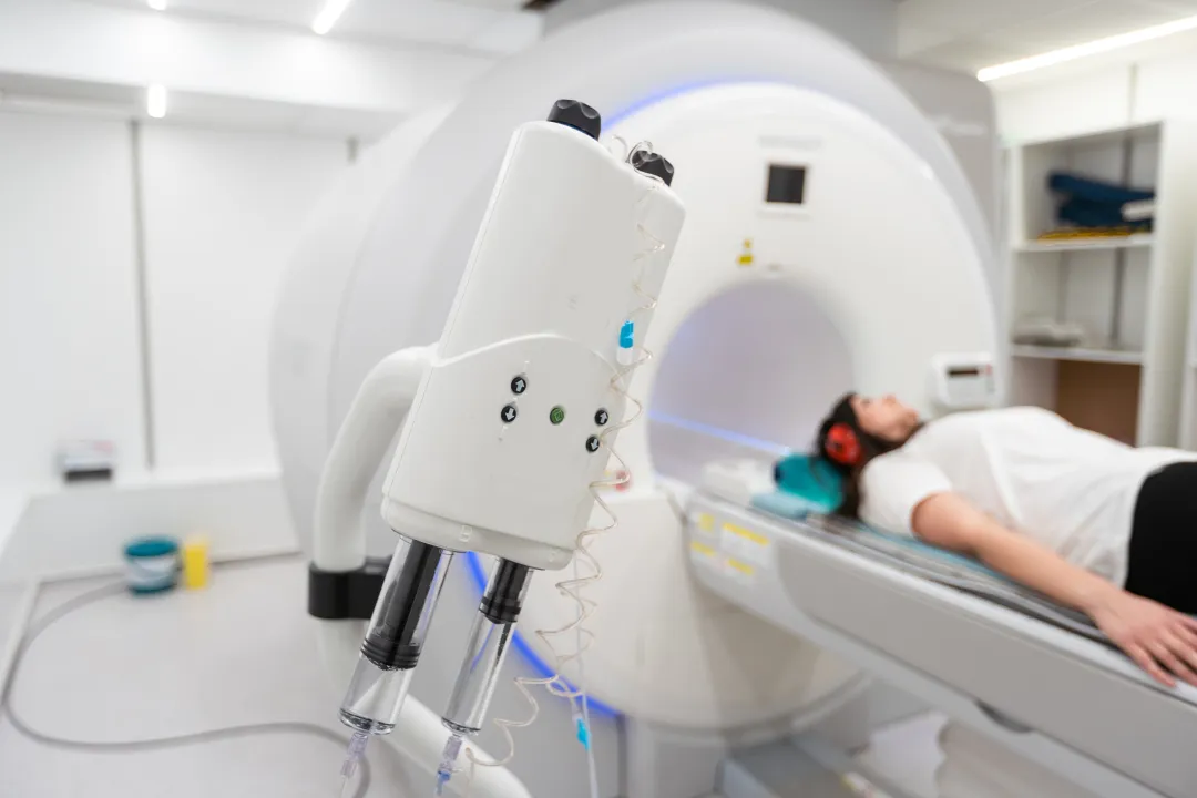 CT scanner room with patient undergoing imaging examination for acute abdomen evaluation